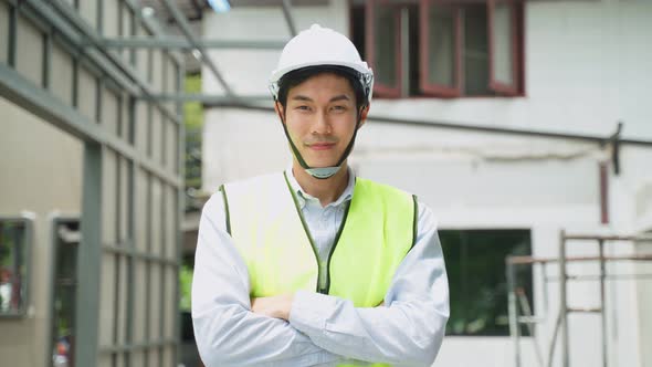 Portrait of Asian colleague male worker people wearing protective safety helmet and glasses onsite.