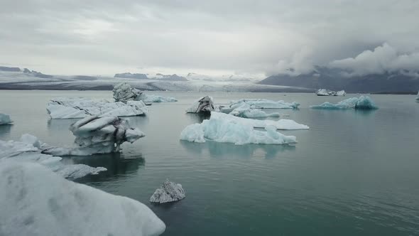 A drone footage of a boat in between the icebergs