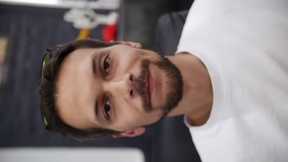 Man Blogger in White Tshirt Says Something to the Camera in Recording Studio