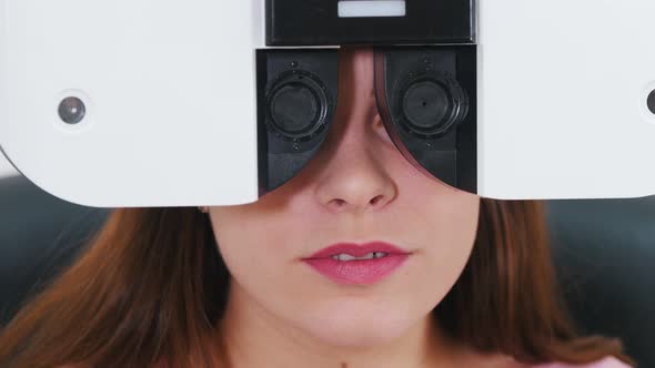 Young Woman Checking Her Visual Acuity with a Special Optometry