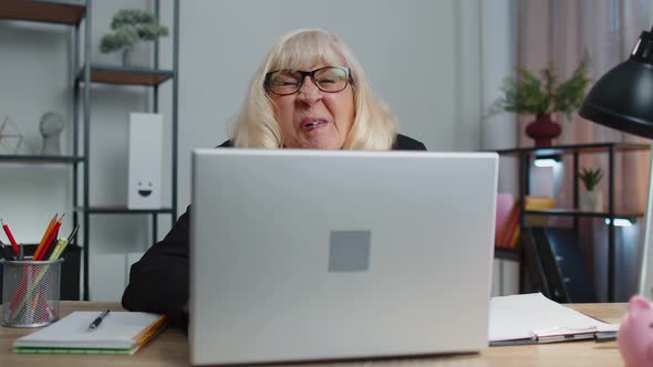 Senior Mature Older Business Woman Hiding Behind Laptop Computer Making Funny Face Fooling Around