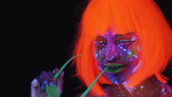 Girl with Glowing Patterns on Her Skin with Orange Hair and Green Disco Glasses