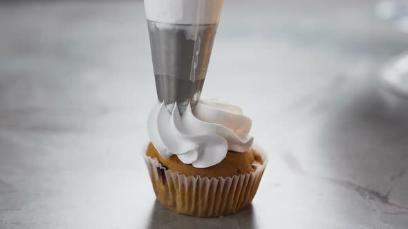 Pastry Bag Putting Cream on the Cake