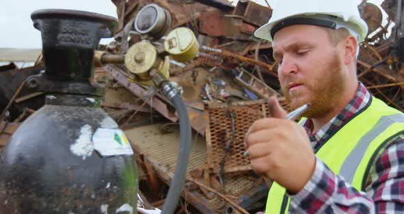 Male worker examining gas cylinder 