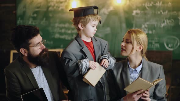 Parents with Kids Ready for School. Home Education Concept. Cute Child Is Sitting at a Desk Indoors.