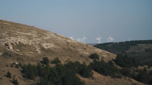 The view up in the hills with windmills in the distance