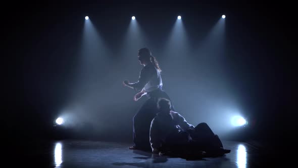 Two Persons in Black Hakama Practice Aikido on Martial Arts Training