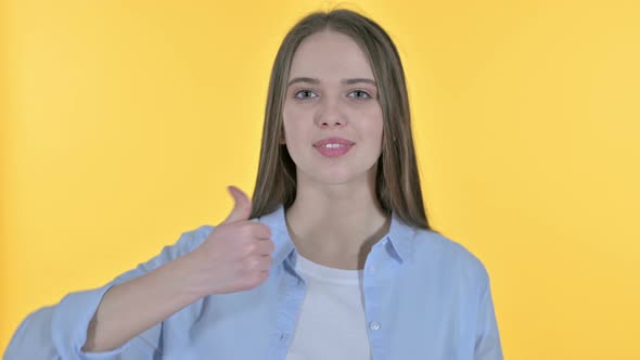 Cheerful Casual Young Woman Showing Thumbs Up