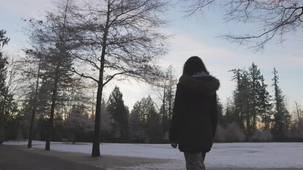 Girl Walking in a Park During Foggy Winter Sunrise