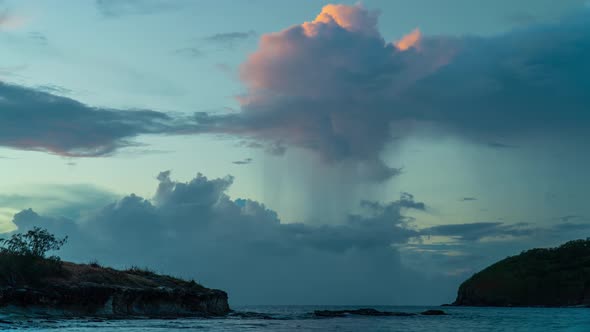 Timelapse of clouds illuminated with vivid colors by sunset, day to night