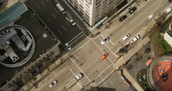 Time lapse from above of busy downtown Vancouver intersection with pedestrians and traffic in motion