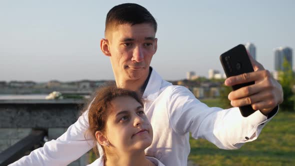 Young Disabled Couple Makes Selfies Grimacing to Smartphone