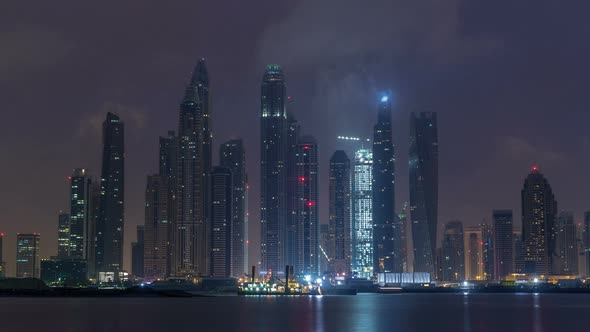 Panorama of Modern Skyscrapers in Dubai City Night to Day Timelapse From the Palm Jumeirah Island