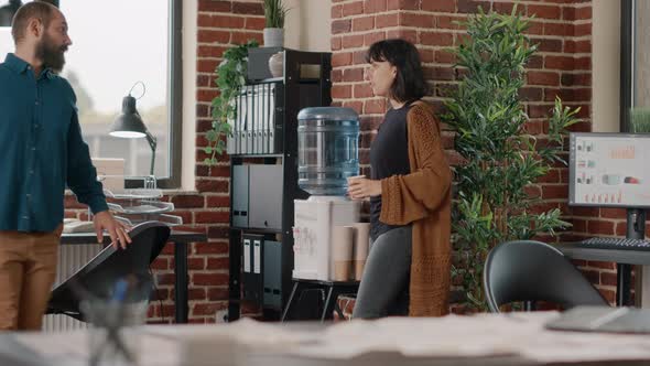 Colleagues Meeting on Break While Having Refreshment From Water Cooler