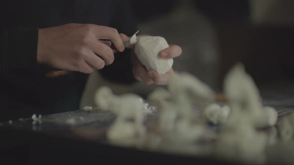 Close-up shot of man making handmade meerschaum pipe