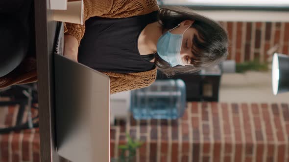 Portrait of Business Woman Wearing Face Mask at Desk