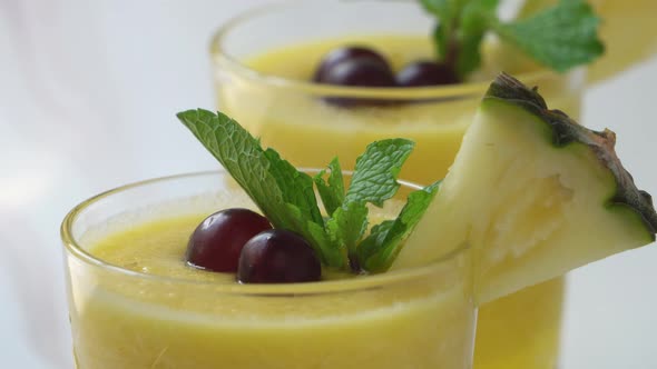 Closeup shot of healthy fresh tropical pineapple smoothies drinks in the glasses