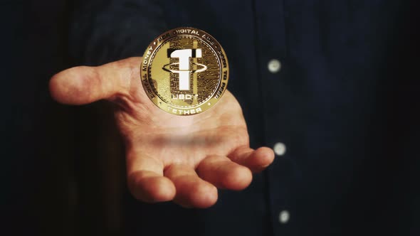 Tether USDT stablecoin cryptocurrency golden 3d coin over hand