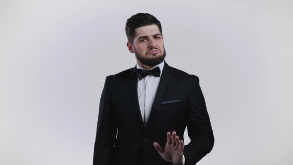 Inflexible Man with Beard in Official Wear Tuxedo Disapproving with No Head Sign Nods Head