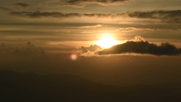 Time lapse shot of golden sunset over mountain range