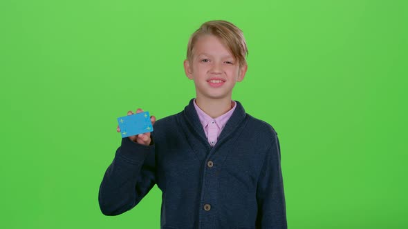 Child Boy with a Credit Card Shows Like on a Green Screen