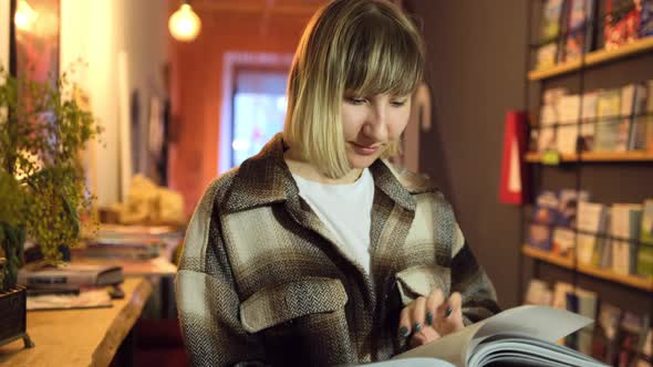 Woman Reading Book in Library