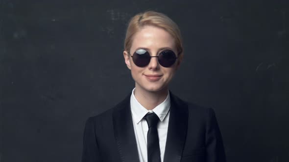businesswoman in a classic business suit and sunglasses