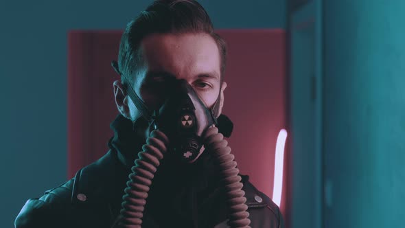 Brutal Man in a Respirator Looking To Camera at Night Over Neon Lights in the Style of Cyberpunk