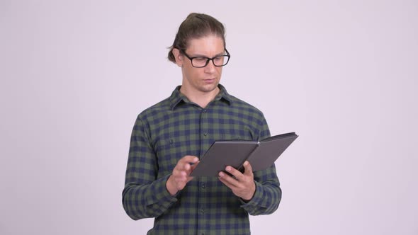 Happy Hipster Man Smiling While Reading Book