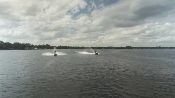 Two wave runners riding very fast