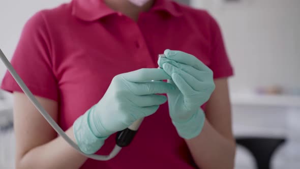 Close View of Female Dentist in Gloves Preparing the Dental Tool