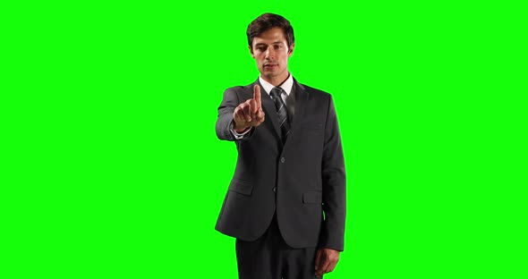 Front view of a Caucasian man touching the screen with green screen