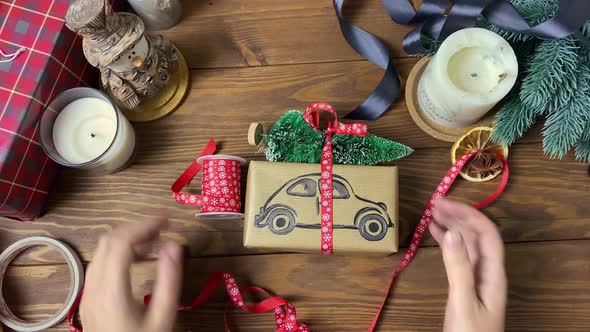 Woman Demonstrates Decor of Christmas Gift