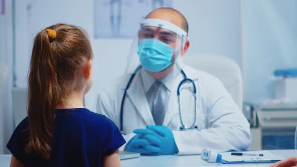 Friendly Doctor Talking with Litttle Patient