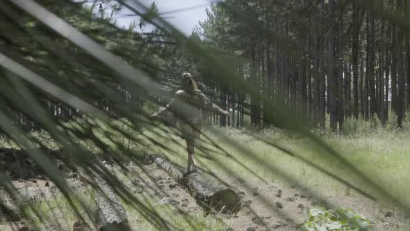 Woman walking on fallen log