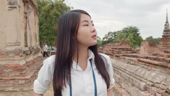 Japanese backpacker female enjoy her journey at amazing landmark in traditional city.