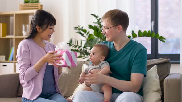 Happy Family with Gift and Baby Boy at Home 18