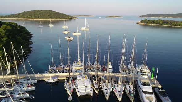 Aerial view of marina with moored white luxury yachts in mediterranean city