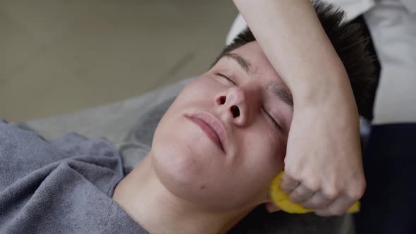 View of Beautician's Hands Wipe the Man's Face with Sponge During the Procedure