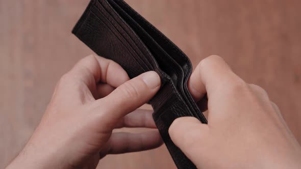 Empty Leather Wallet in the Hands of a Man Closeup