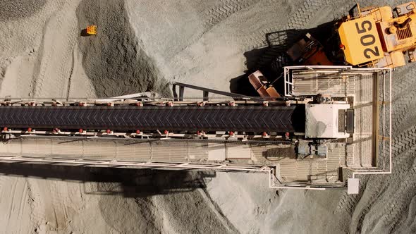 Aerial Top Down of Coal Conveyor Belt Piling Up Coal at a Depot