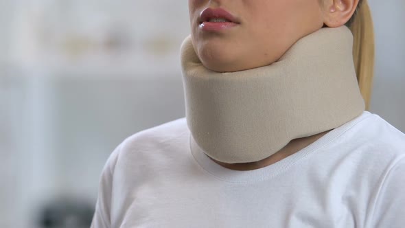 Woman in Foam Cervical Collar Feeling Neck Pain After Trauma, Rehabilitation