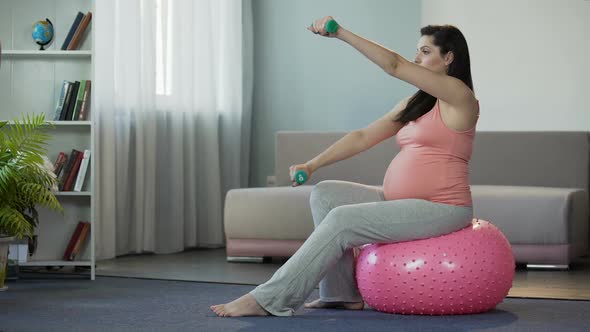 Pregnant Woman Living Active Lifestyle, Doing Exercises, Pumping Her Muscles