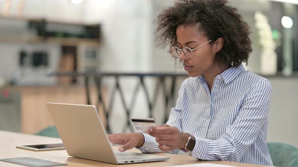 Successful Online Payment By African Businesswoman on Laptop in Office 