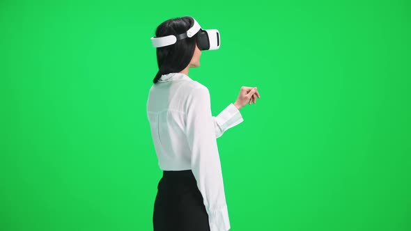 Female in Futuristic Virtual Reality Glasses Controls the Virtual Interface with a Hands Movement