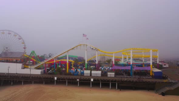 Side view of the Santa Monica Pier on a foggy day.