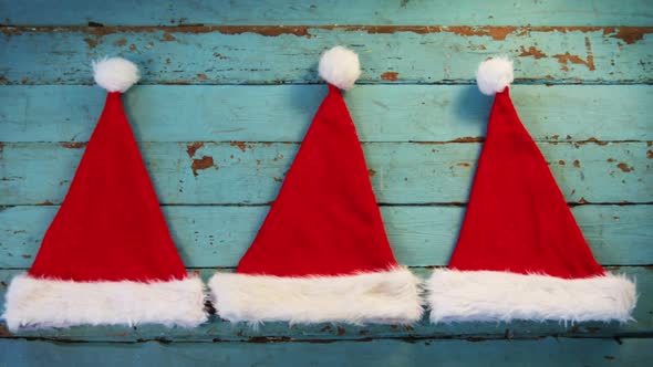 Santa hats on wooden plank