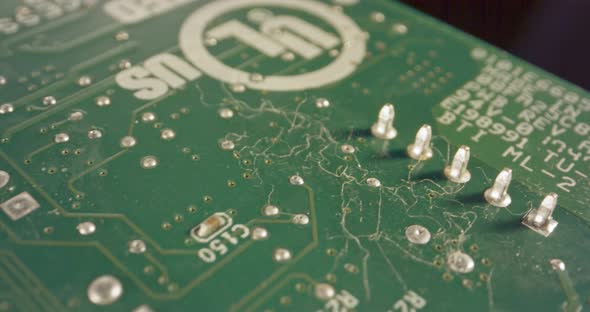 Extreme macro dolly shot of a PCB computer board with capacitors and transistors