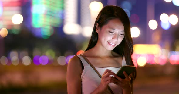 Asian woman use of mobile phone at night