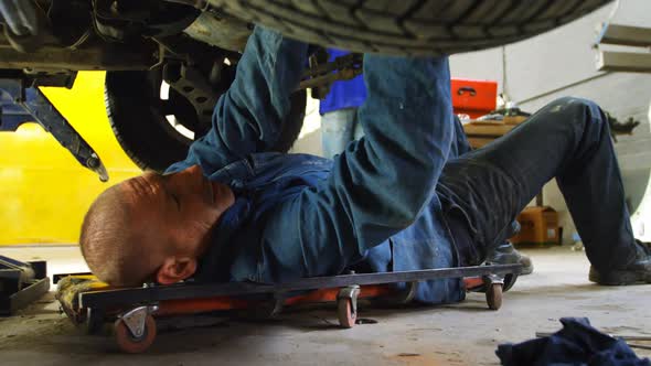 Mechanic examining a car 4k